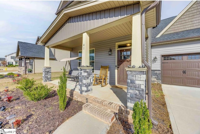 doorway to property featuring a porch and a garage