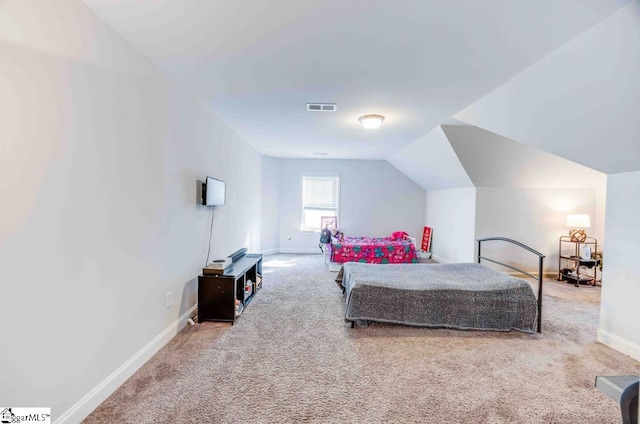 bedroom with carpet flooring and lofted ceiling