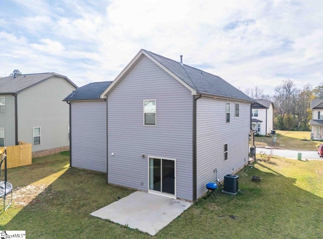 back of property with a patio area, a yard, and central air condition unit