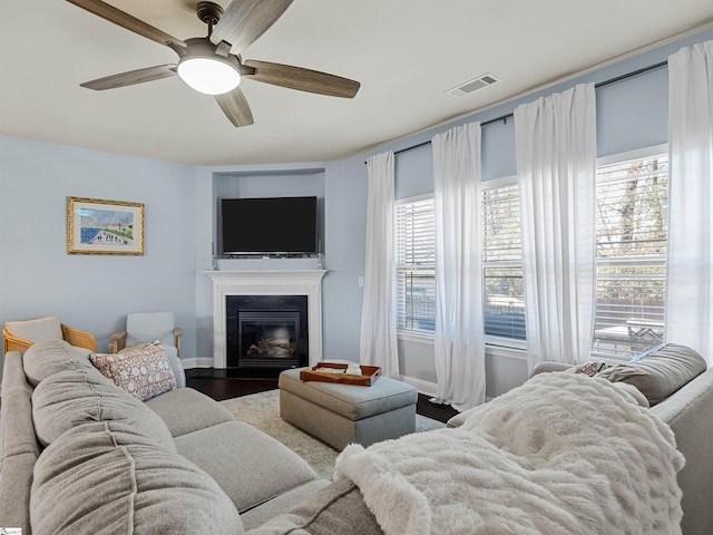 living room featuring ceiling fan and hardwood / wood-style floors