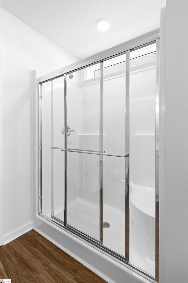 bathroom featuring hardwood / wood-style floors and an enclosed shower