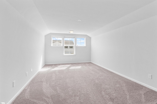 bonus room with light carpet and lofted ceiling