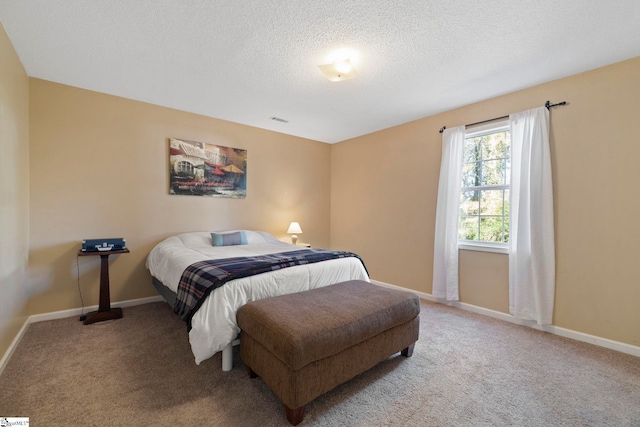 carpeted bedroom with a textured ceiling