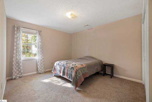 carpeted bedroom with a textured ceiling