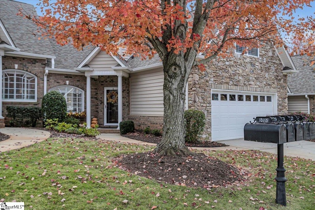 view of front of property with a front yard and a garage