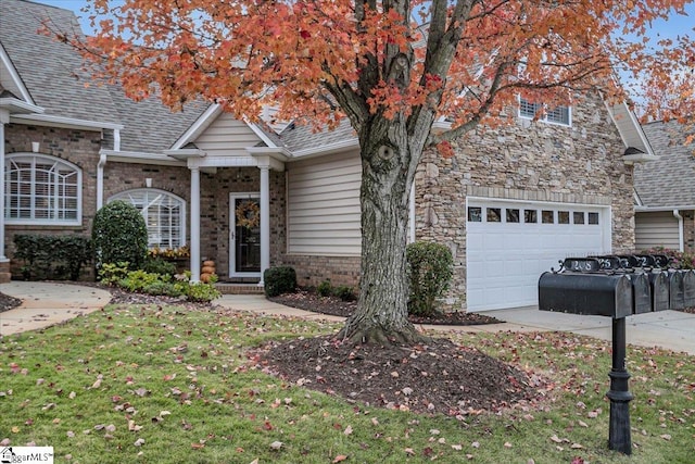 view of front of property with a front yard and a garage