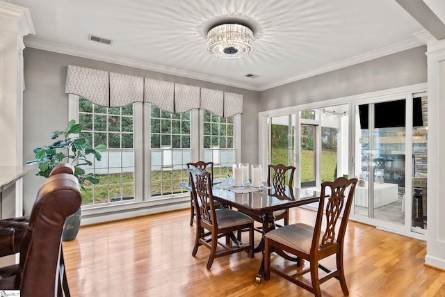 sunroom / solarium with plenty of natural light, a chandelier, and a baseboard heating unit