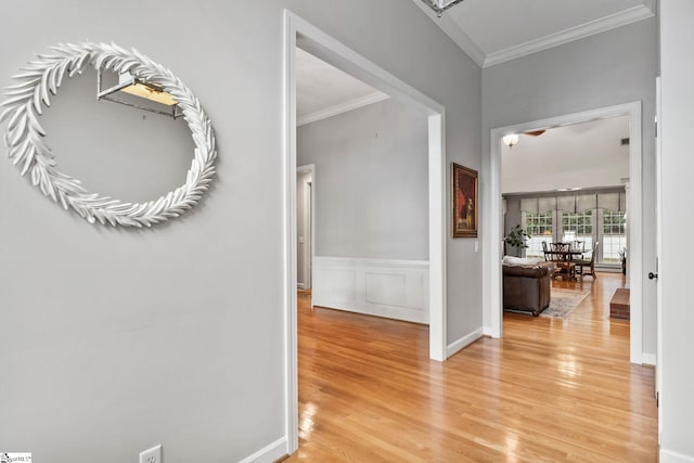 hall featuring wood-type flooring and ornamental molding