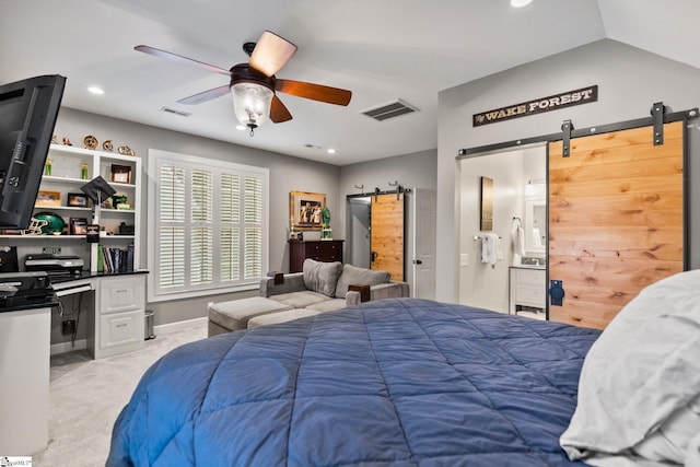 bedroom featuring ceiling fan, a barn door, lofted ceiling, and light carpet