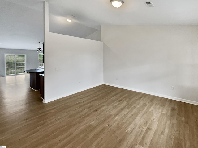 unfurnished room featuring dark hardwood / wood-style flooring and vaulted ceiling