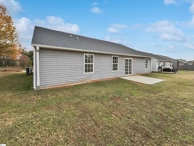 rear view of house with a yard, a patio, and cooling unit