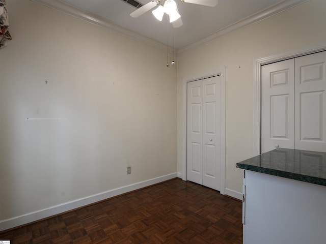 interior space featuring ceiling fan, dark parquet flooring, and ornamental molding