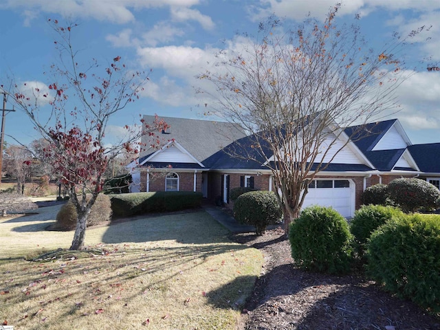 ranch-style house with a garage and a front yard