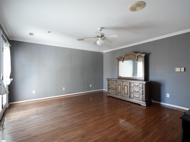 empty room featuring ceiling fan, dark hardwood / wood-style floors, and ornamental molding