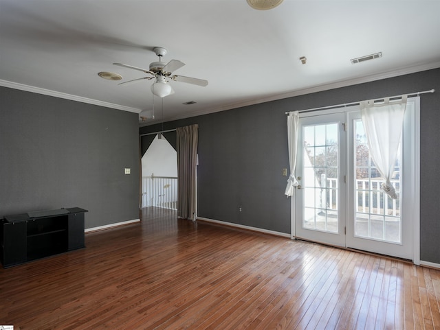 spare room featuring wood-type flooring, ceiling fan, and crown molding