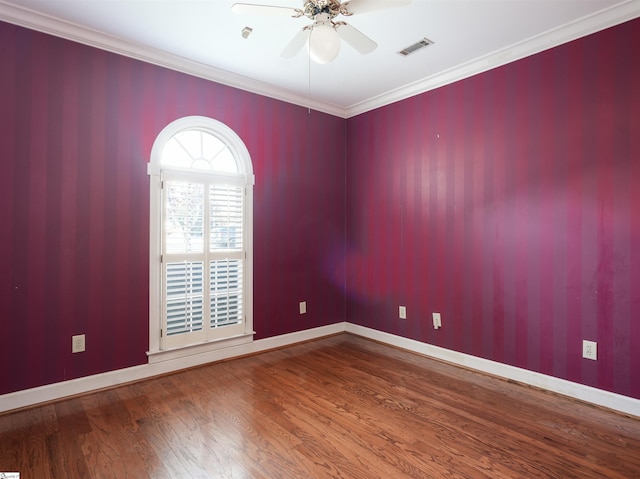 spare room with hardwood / wood-style floors, ceiling fan, and ornamental molding