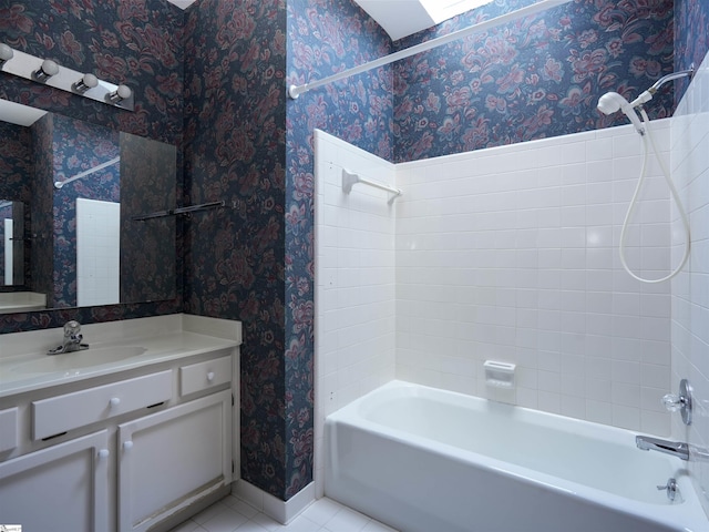 bathroom featuring tile patterned flooring, vanity, and tiled shower / bath