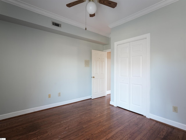 unfurnished bedroom with a closet, ceiling fan, crown molding, and dark hardwood / wood-style floors