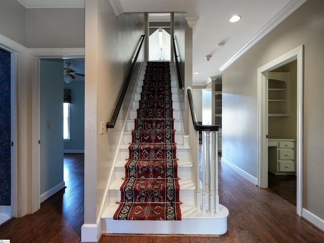 stairs with ceiling fan, hardwood / wood-style floors, and ornamental molding