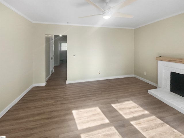 unfurnished living room with hardwood / wood-style flooring, ceiling fan, ornamental molding, and a fireplace