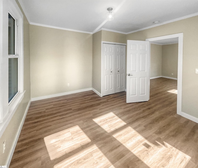 105 Duncan Ave, Greer, SC 29651 - unfurnished bedroom featuring baseboards, ornamental molding, wood finished floors, and a closet