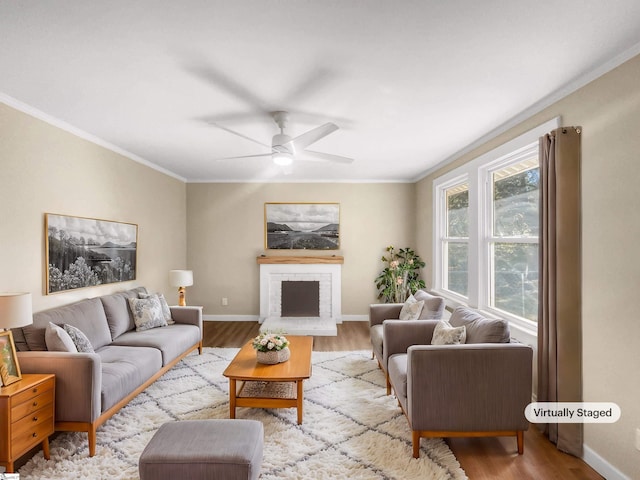 living room featuring light hardwood / wood-style flooring, ceiling fan, and ornamental molding