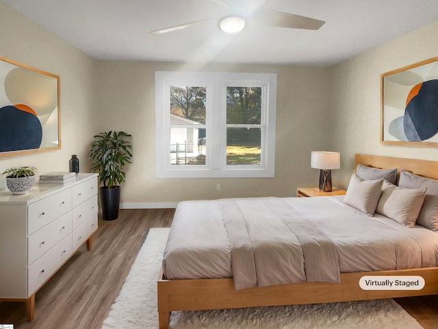 bedroom featuring hardwood / wood-style floors and ceiling fan