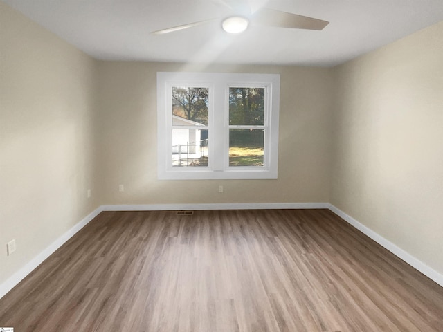 unfurnished room with ceiling fan and wood-type flooring