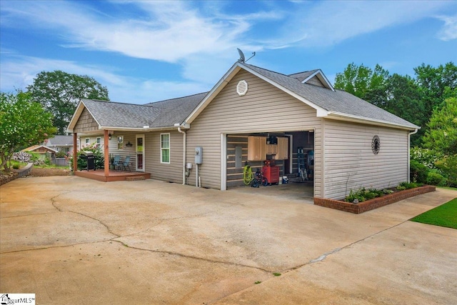 view of property exterior featuring a porch and a garage