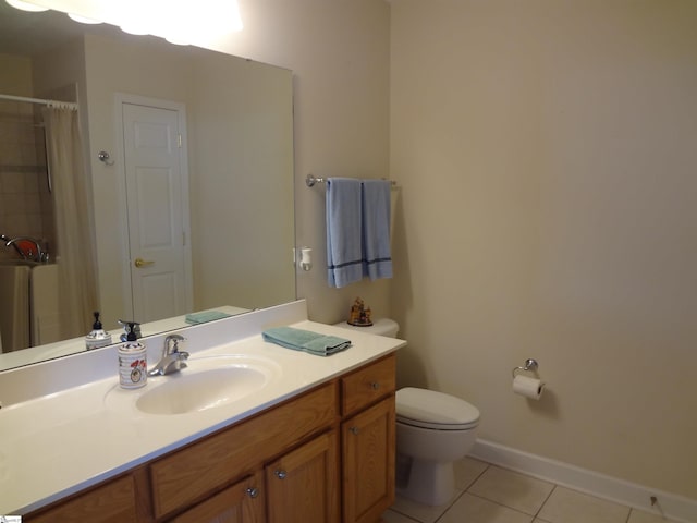 bathroom with tile patterned floors, curtained shower, vanity, and toilet