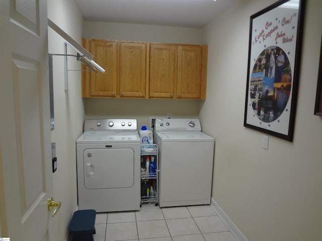 washroom featuring cabinets, independent washer and dryer, and light tile patterned floors