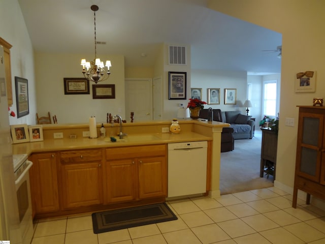 kitchen with ceiling fan with notable chandelier, white appliances, sink, light tile patterned floors, and pendant lighting