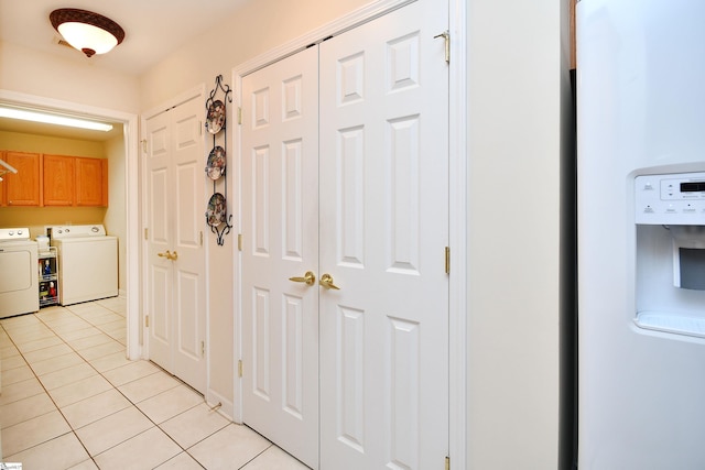 interior space featuring separate washer and dryer and light tile patterned flooring