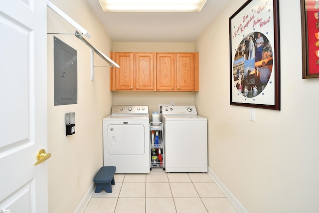 clothes washing area featuring electric panel, light tile patterned flooring, cabinets, and independent washer and dryer