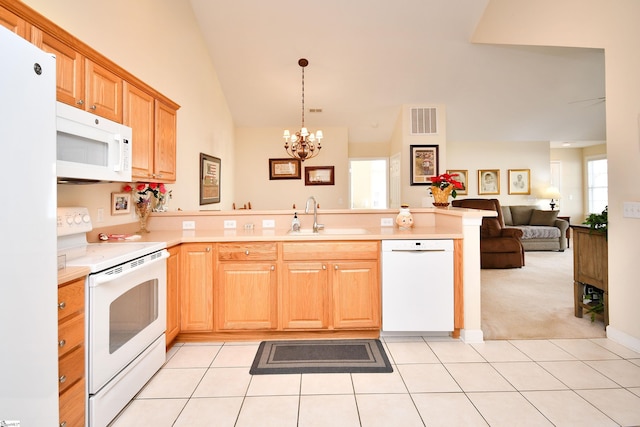 kitchen with white appliances, light colored carpet, sink, pendant lighting, and an inviting chandelier