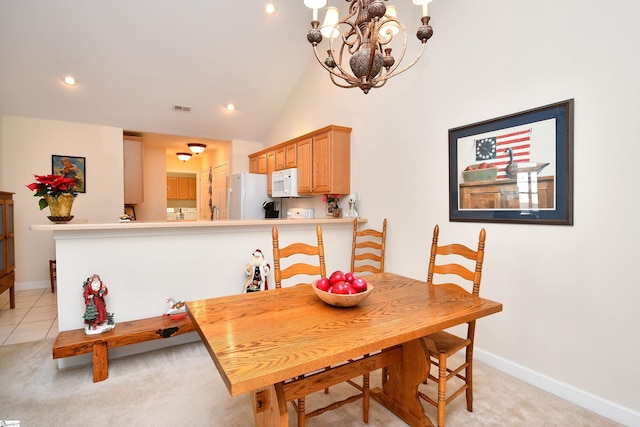 carpeted dining space featuring a notable chandelier and vaulted ceiling