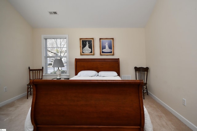 carpeted bedroom with lofted ceiling