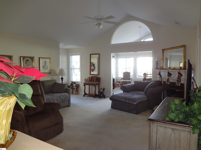 living room featuring ceiling fan, light colored carpet, and lofted ceiling