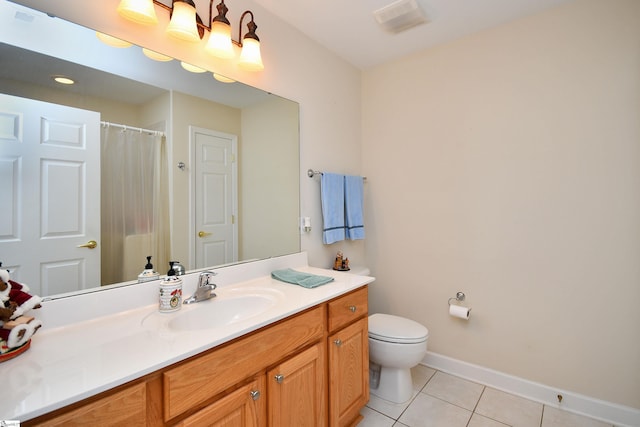 bathroom with tile patterned floors, vanity, and toilet