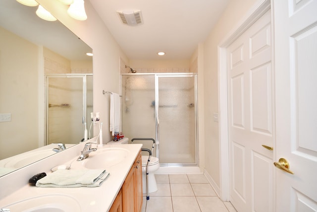 bathroom with tile patterned flooring, vanity, toilet, and walk in shower