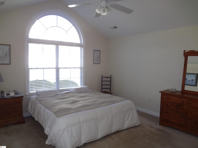 carpeted bedroom featuring vaulted ceiling and ceiling fan