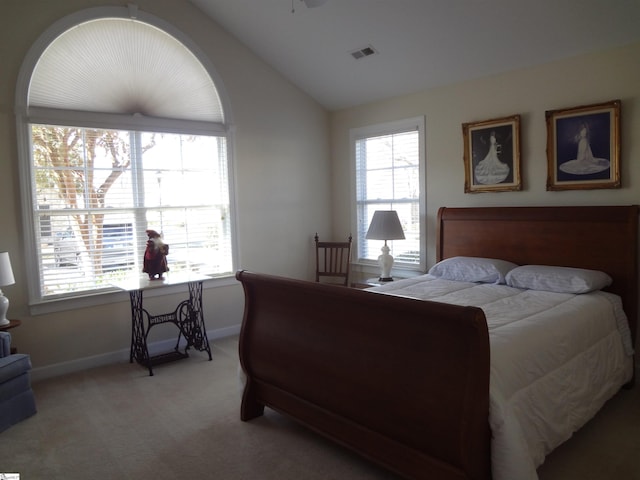 bedroom featuring light colored carpet, multiple windows, and lofted ceiling