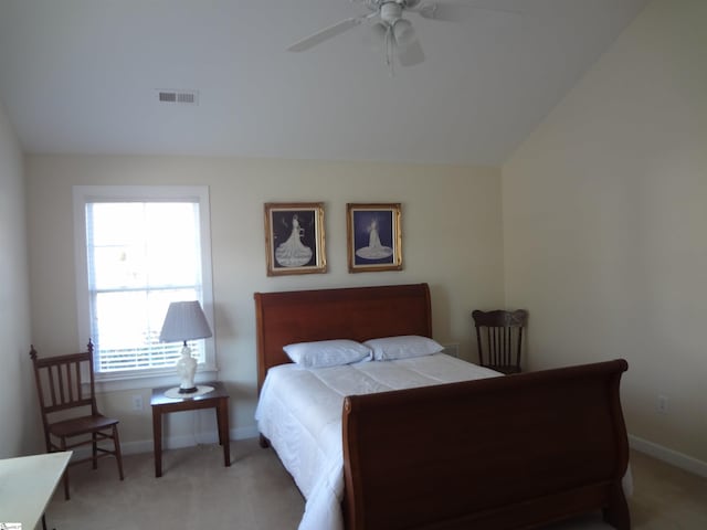 carpeted bedroom with vaulted ceiling and ceiling fan