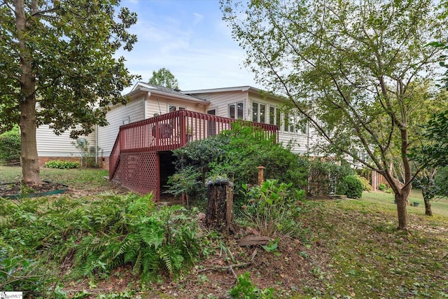 back of property featuring a wooden deck