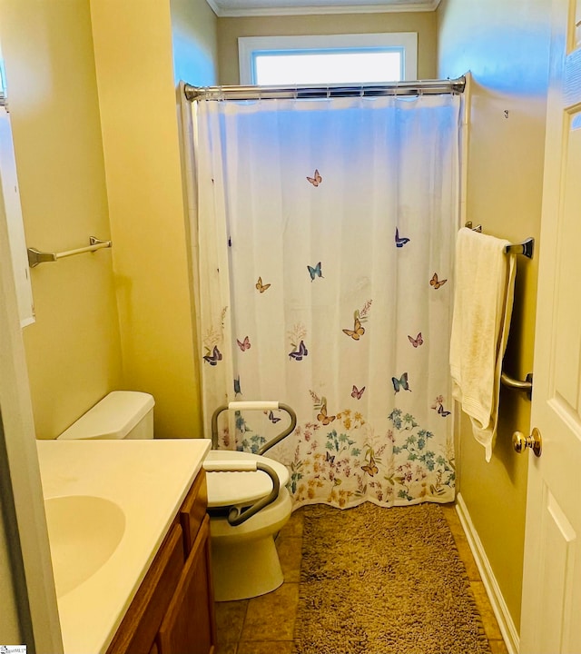 bathroom featuring crown molding, vanity, and toilet