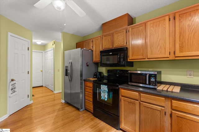 kitchen with ceiling fan, light hardwood / wood-style flooring, black appliances, and a textured ceiling