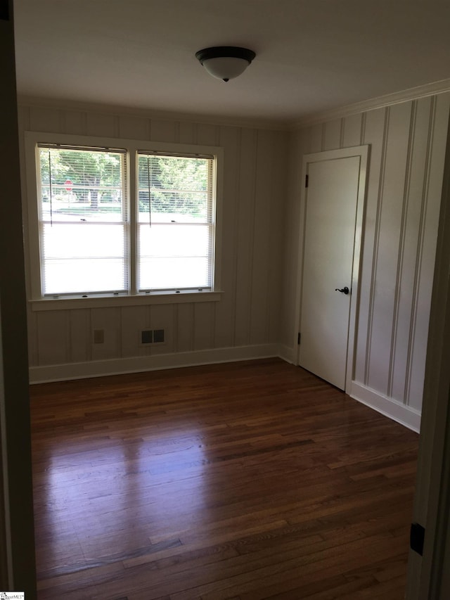 spare room featuring dark hardwood / wood-style flooring