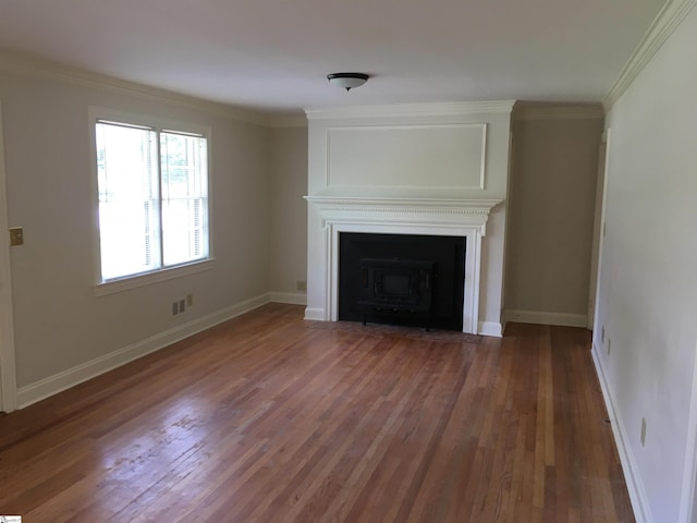 unfurnished living room featuring a wood stove, dark hardwood / wood-style floors, and ornamental molding