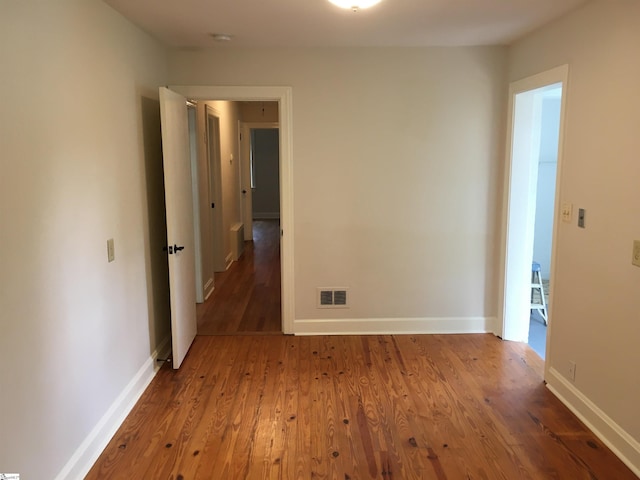 spare room featuring hardwood / wood-style floors