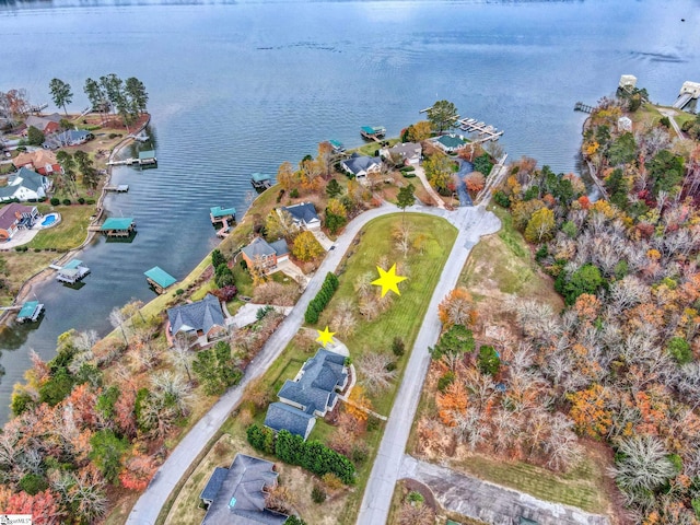 birds eye view of property with a water view